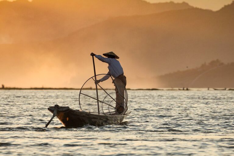 asian-fisherman-on-boat-at-sunset-DVCPENS.jpg